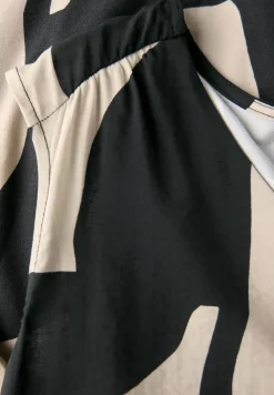 Top in structuurmix met print